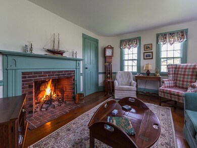 The living room with original mantel...