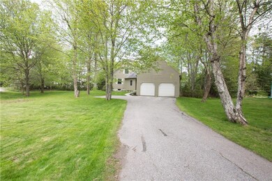 The paved driveway leads to a large...