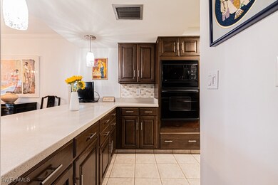 Kitchen featuring pendant lighting, crown molding,