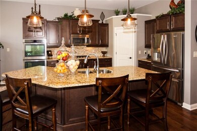Gourmet kitchen is loaded with granite counters, high end SS package, tile back splash, and center island/breakfast bar. 