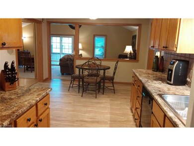 Kitchen/dinette looks into living room/dining