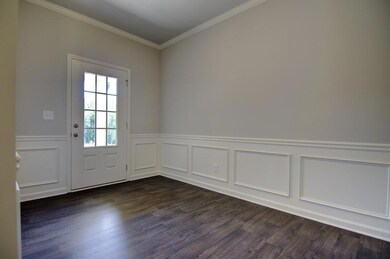 Entryway with dark hardwood / wood-style flooring 