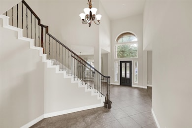 The two-story foyer feels bright and expansive, wi