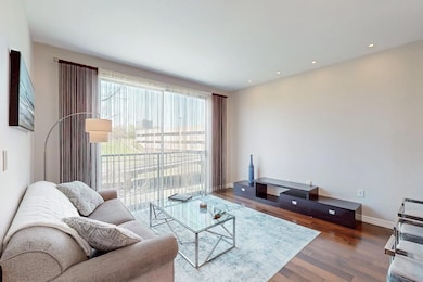 Living area with baseboards, wood finished floors,