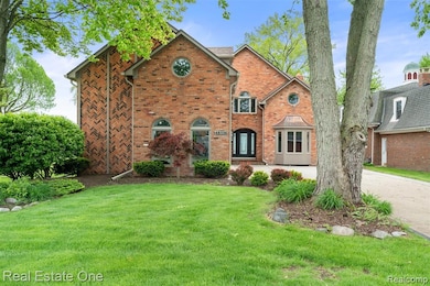 View of front of property featuring a front yard and brick siding