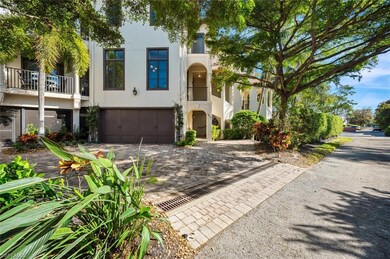 View of front of house with a garage and a balcony