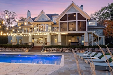 Gracefully situated on 2.05 acres, the outdoor living areas are just as impressive with a generous deck, covered patio, hot tub, inground swimming pool surrounded with paver stone decking, professional landscaping, and 220 feet of shoreline on Silver