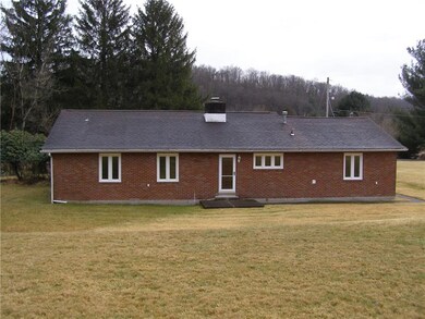 View from the backyard.  Cement patio and walkway 