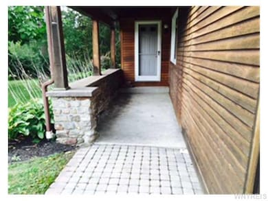 Exterior Front. Covered porch with stone and path 