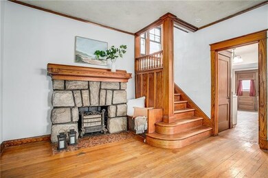 Entryway with built in bench and original stone fi