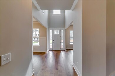 Foyer featuring dark wood-style flooring and baseb