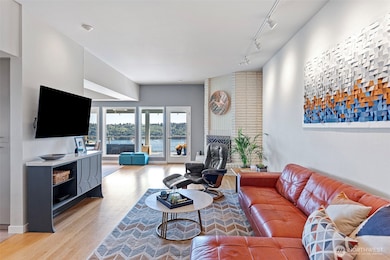 Refinished hardwood oak floors cover much of the main living spaces. The first of three wood-burning fireplaces anchors the room.