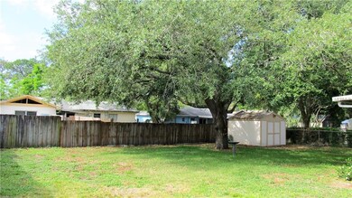 Huge fenced in yard with mature oak tree