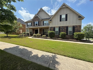 Craftsman house with board and batten siding, stone siding, and a front yard