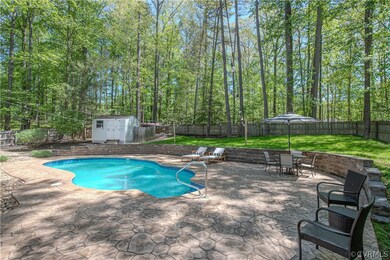 View of swimming pool with a patio area, a storage
