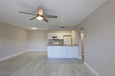 Kitchen with white appliances, a sink, white cabin