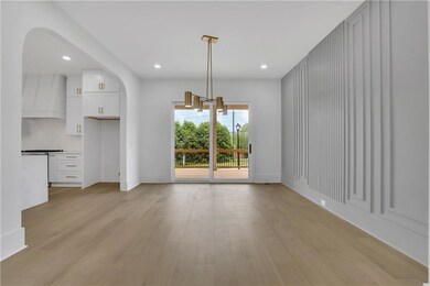 Unfurnished dining area featuring arched walkways,