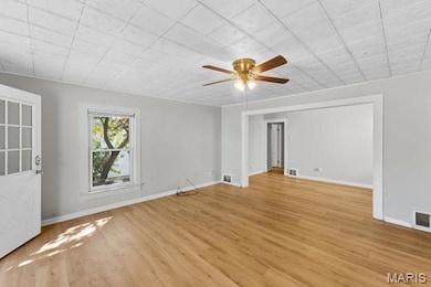 Unfurnished room featuring light wood-style floors and a ceiling fan