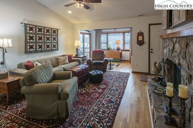 LIVING ROOM WITH VAULTED CEILINGS, WOOD FLOORS AND