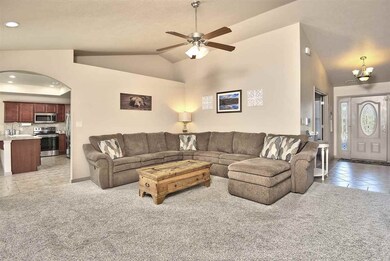 Newly carpeted living room opens into kitchen and 