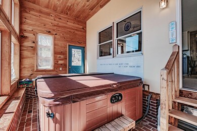 Sunroom with hot tub.
