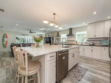 Kitchen with a kitchen island with sink, stainless