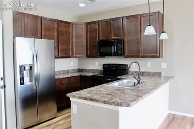 Tall cabinets and stainless steel refrigerator