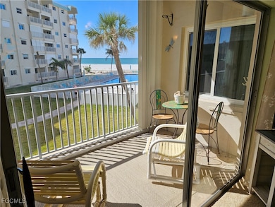 Balcony with view of water and beach