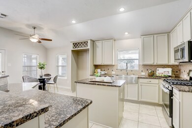 Newly updated kitchen with stainless steel appliances and farmhouse sink.