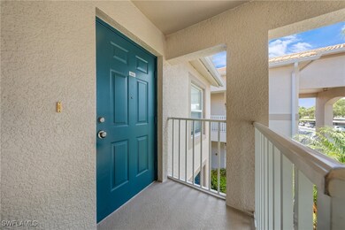 Entrance to property with a balcony and stucco sid