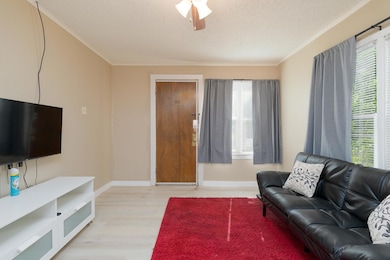 Living room with light wood-style floors, a textur