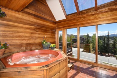 Sun room with hot tub opens to lower deck and has