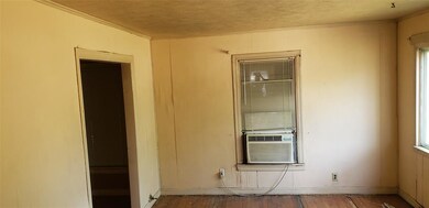 Front living area with  original wood floor.