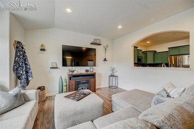 Living room with lofted ceiling and dark wood-type