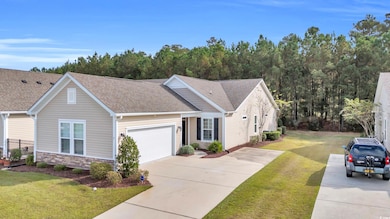 View of front of home with a garage and a front la
