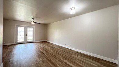 Spare room with dark wood-style flooring, french 