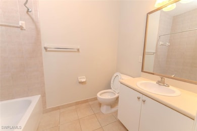 Bathroom with tile patterned floors, toilet, vanit