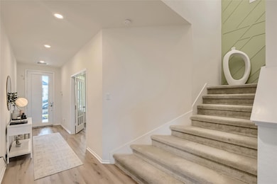 Foyer featuring stairway, wood finished floors, a
