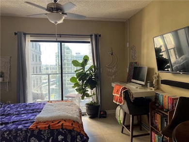 Tiled bedroom featuring a textured ceiling and cei
