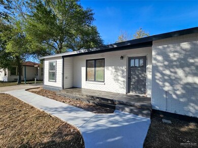 Entrance to property featuring brick siding