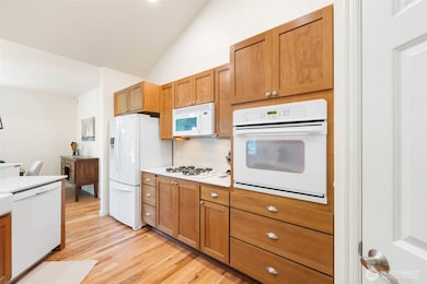 Open kitchen with beautiful cabinetry, brand-new countertops, and a gas cooktop.