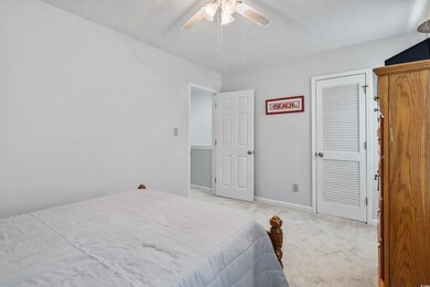 Bedroom featuring ceiling fan and carpet floors