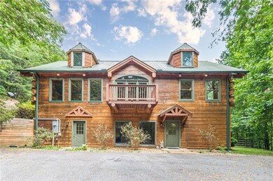 View of front of house with a balcony and fence
