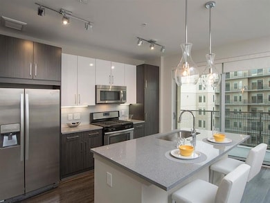 Kitchen featuring hanging light fixtures, rail lig