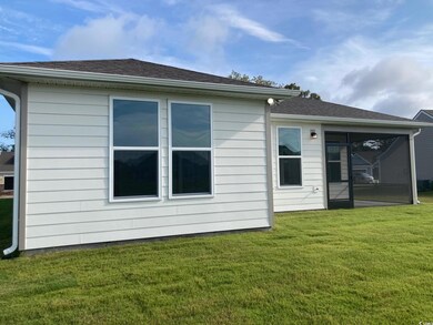 Back of house featuring a lawn featuring a screene