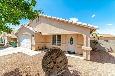 View of front of home with stucco siding, a garage