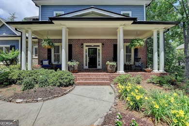 Large charming and welcoming front porch with beautiful flower garden views!