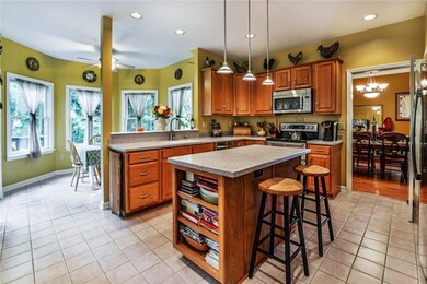 Kitchen features stainless appliances, center isla