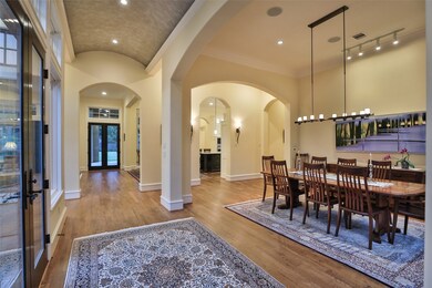 Spacious dining room to the right with view of the interior courtyard. Hubbardton Forge chandelier and track lighting set the tone here. All wood floors are job finished and stained.