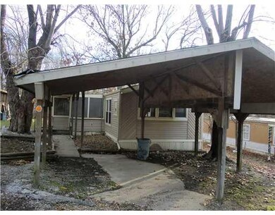 Exterior Front. Carport....Enter Through Enclosed Porch